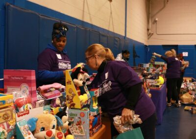 volunteers work at event organizing toys