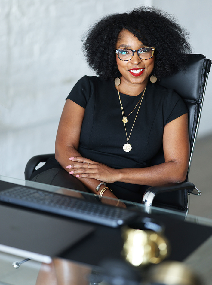 egypt graham founder of planning 2 perfection sits at her desk